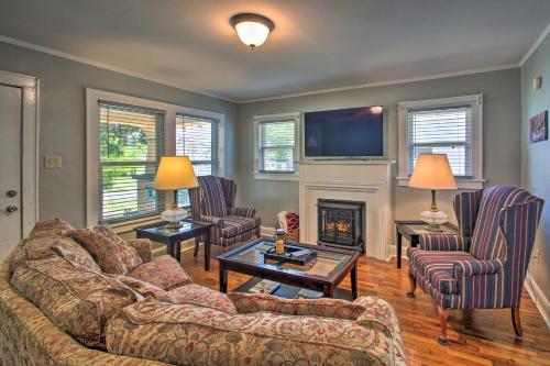 a living room with a couch and a fireplace at Hot Springs Home - Walk to Oaklawn Casino! in Hot Springs