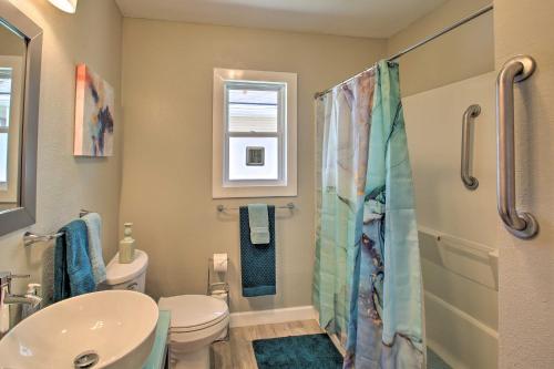 a bathroom with a toilet and a sink at Hot Springs Home - Walk to Oaklawn Casino! in Hot Springs