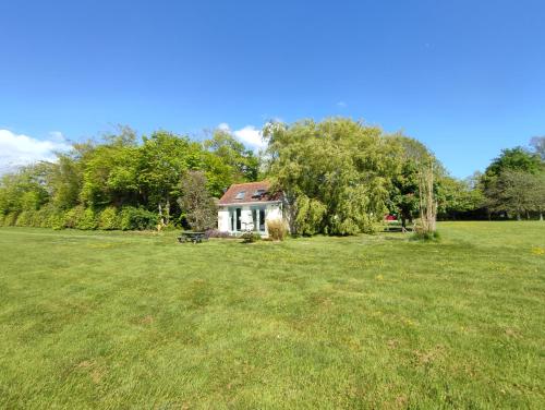 a small house in the middle of a field at The Pump-House in Chichester
