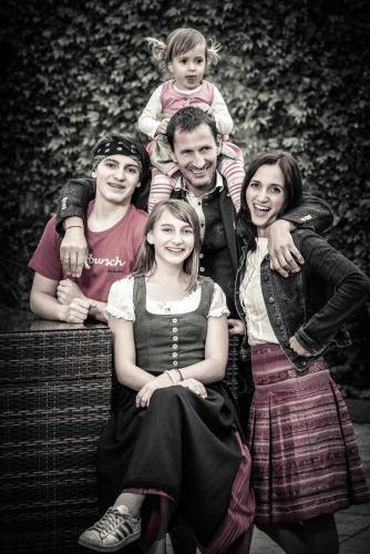 a black and white photo of a family posing for a picture at Hotel Bürglstein in St. Wolfgang