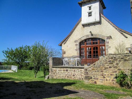 an old stone church with a large window and a balcony at Holiday Home La Grange by Interhome in La Valade