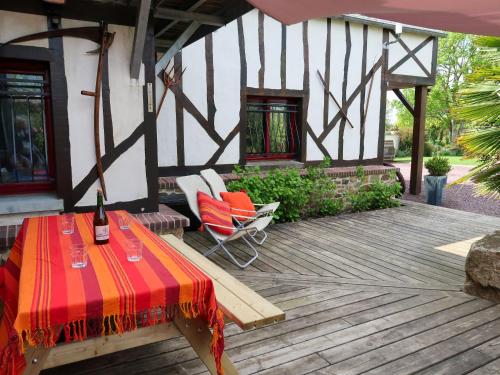 a patio with a table and chairs and a building at Holiday Home Valhalla- chez Jules by Interhome in Planguenoual
