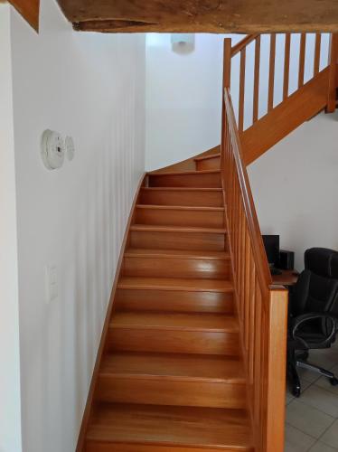 a staircase in a house with wooden floors at Brocéliande calme breton, spa, wifi, amazon-disney tv, 4 lits, Freebox revolution,draps, café, thé in Guer