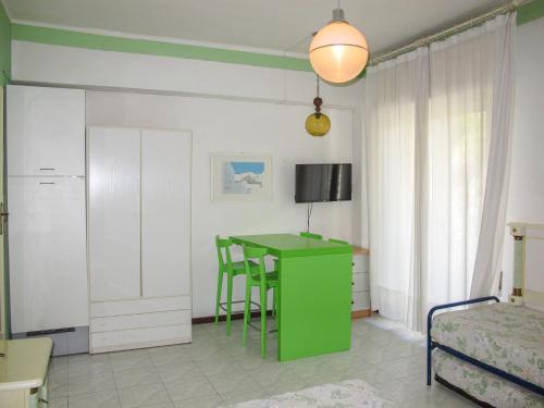 a room with a green table and a bedroom at Apartment Bellavista 7 by Interhome in Cattolica