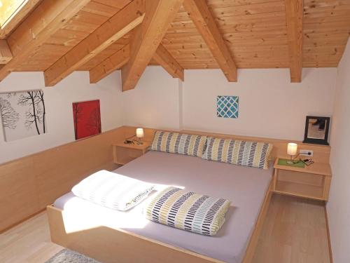 a bedroom with a bed with two pillows at Apartment Frischmann-3 by Interhome in Umhausen