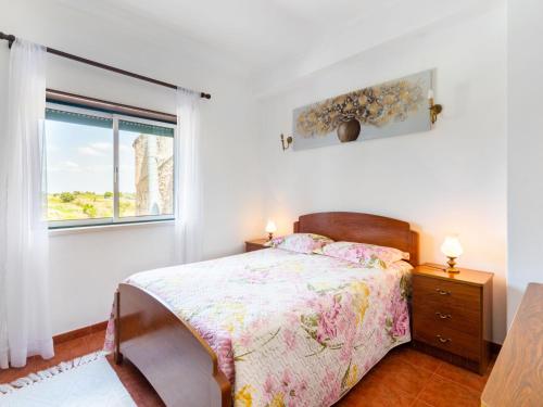a white bedroom with a bed and a window at Holiday Home Das Serradas by Interhome in Vau