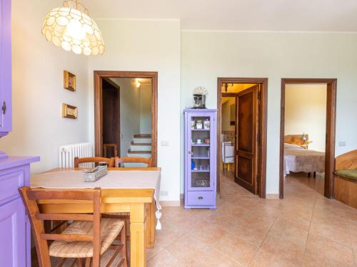 a dining room with a table and a bedroom at Holiday Home Podere Casidote by Interhome in Montieri