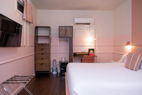 a bedroom with a white bed and a desk at The Russell in Nashville