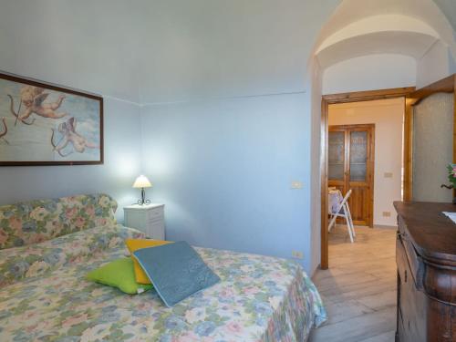a bedroom with a bed with a book on it at Holiday Home Francesca - SLR212 by Interhome in Cipressa