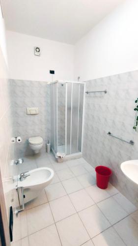 a bathroom with a shower and a toilet and a sink at Hotel Mater Mediterranea in Senorbì