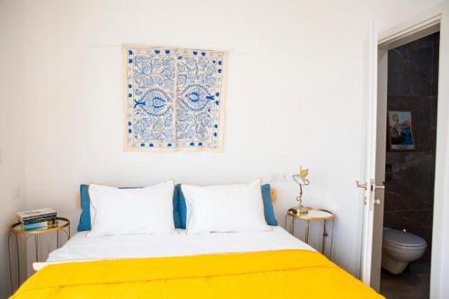 a bedroom with a bed with a yellow blanket at Spa Eilat Mountain Lodge in Eilat