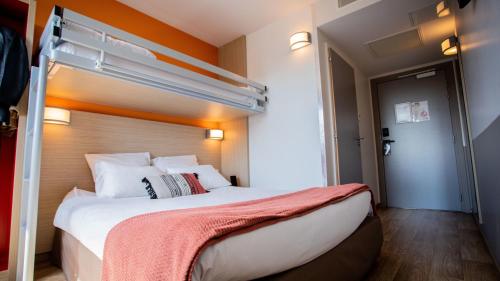 a bedroom with a bed with a bunk bed at Oneloft Hotel in Obernai