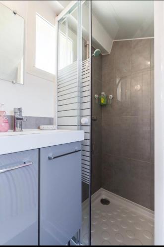 une salle de bain avec une douche avec une porte vitrée dans l'établissement Homelivia, ATTIC ROOM -Mansardé sous les toits de Nice, à Nice