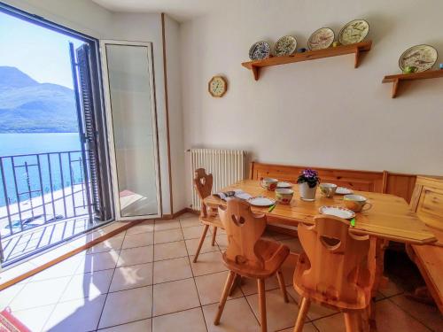 a dining room with a table and a large window at Apartment Relax by Interhome in Gravedona