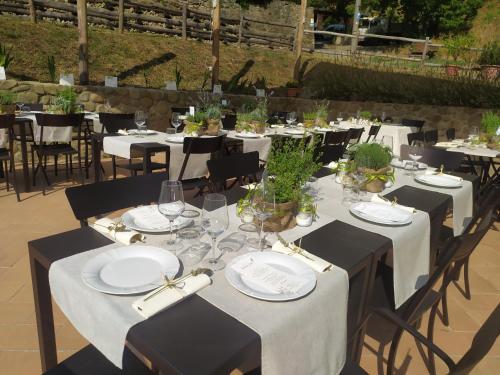 a group of tables with white plates and wine glasses at Il Mulino di Celle in Pistoia