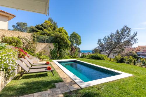 a swimming pool in the yard of a house at House in Estoril in Estoril