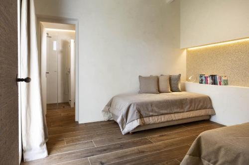 a bedroom with a bed and a book shelf on the wall at Stazzo Lu Ciaccaru in Arzachena