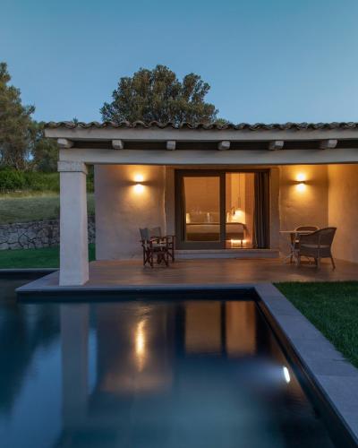 a swimming pool in front of a house at Stazzo Lu Ciaccaru in Arzachena