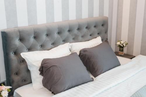 a bed with two gray pillows on it at Vinceia in Smederevo
