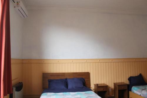 Ein Bett oder Betten in einem Zimmer der Unterkunft Hostal Capricho de Carlitos