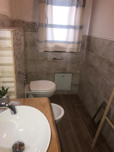 a bathroom with a sink and a toilet at La fragola in Campagna 6 k m da San pantaleo in San Pantaleo