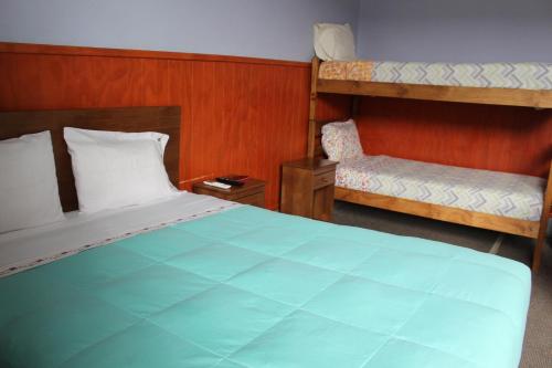 Ein Bett oder Betten in einem Zimmer der Unterkunft Hostal Capricho de Carlitos