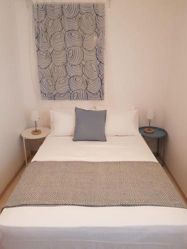 a bed in a room with two side tables at Casa Ble - Izla Homes in Skala Kefalonias