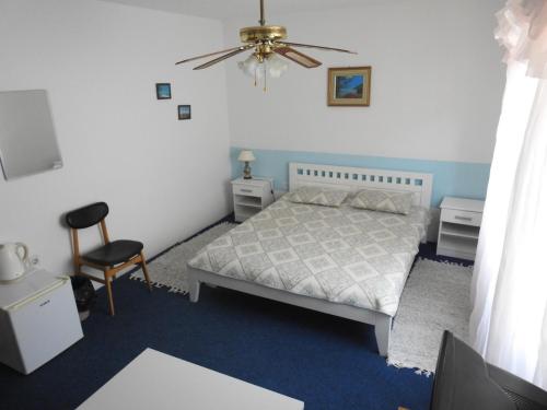 a bedroom with a bed and a chair at Madam Svetlana in Tivat