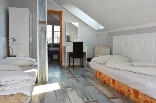a room with two beds and a desk with a chair at Twins in Hurbanovo