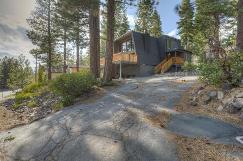 a house in the woods with a driveway at Dollar Point in Tahoe City
