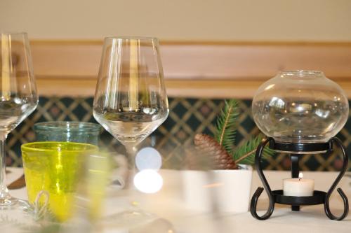 three wine glasses sitting on top of a table at hotel Parco Pineta in Cavareno