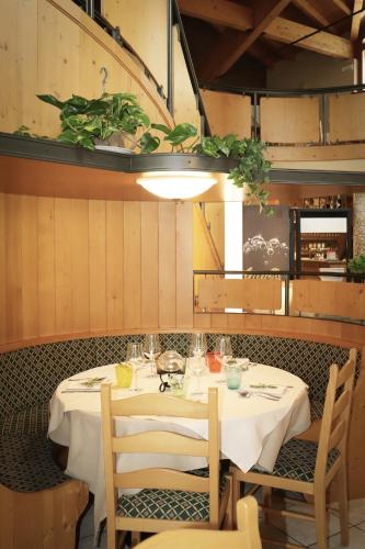 a table in a restaurant with a white table cloth at hotel Parco Pineta in Cavareno