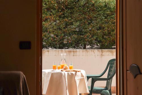 a table with a bottle of orange juice on it at hotel Parco Pineta in Cavareno