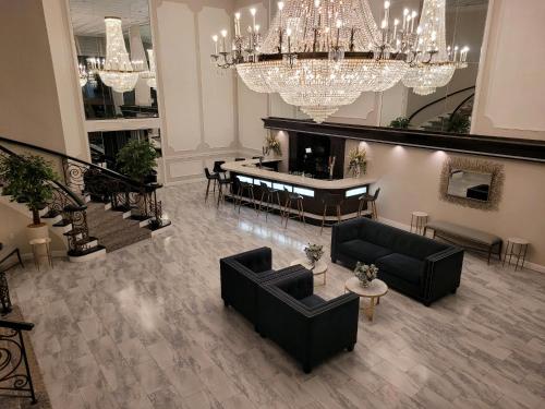 a living room with chandeliers and a table and chairs at The Shore Club in Spring Lake Heights