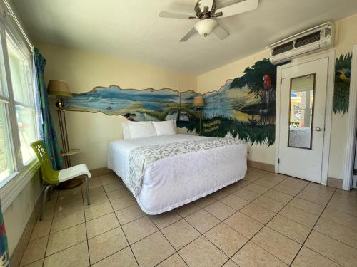 a bedroom with a bed and a painting on the wall at Magic Beach Motel - Vilano Beach, Saint Augustine in Saint Augustine