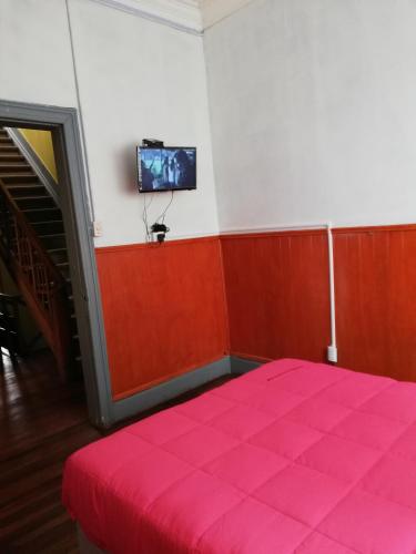 Ein Bett oder Betten in einem Zimmer der Unterkunft Hostal Capricho de Carlitos