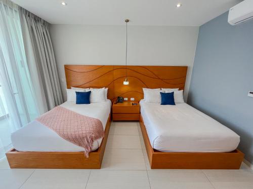 Ένα ή περισσότερα κρεβάτια σε δωμάτιο στο Hotel Puerto Libre