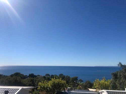 a view of the ocean from a house at Mobil Home superbe Vue Mer St Raphaël in Saint-Raphaël