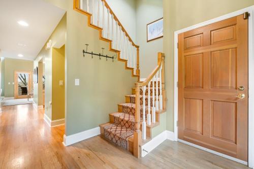 a hallway with a wooden door and a staircase at Yonahlossee Mountain Magic in Boone