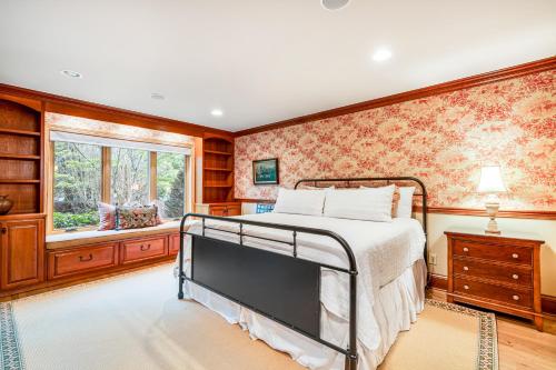 a bedroom with a bed and a window at Yonahlossee Mountain Magic in Boone