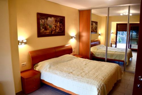 a hotel room with a bed and a mirror at Family Villa in Petrovac na Moru