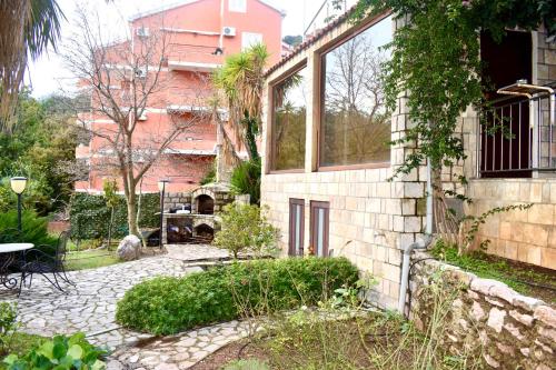 a brick building with a patio and a courtyard at Family Villa in Petrovac na Moru