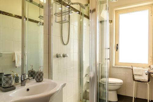 a bathroom with a sink and a shower and a toilet at La Casa Di Stefe in Giardini Naxos