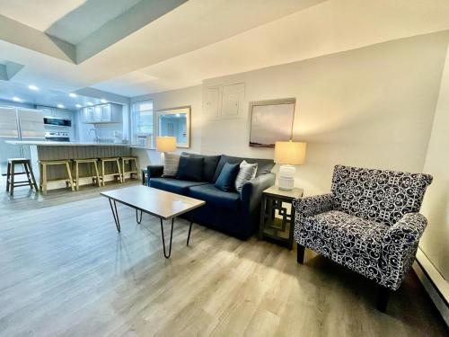 a living room with a couch and a table and a chair at Blue Water Inn in Ocean City