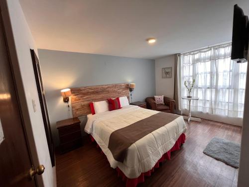 a bedroom with a large bed and a window at Chikan Hoteles in Arequipa
