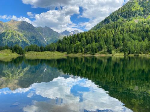 a reflection of the mountains in a lake at JOHANN Schladming in Schladming