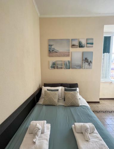 a bed in a room with two towels at Domus Lido in Lido di Ostia