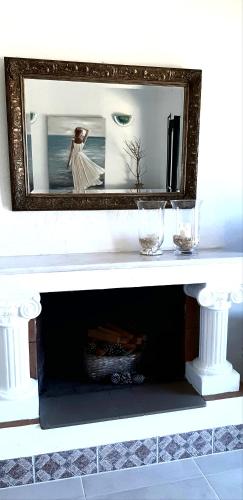 a mirror on top of a shelf with two glasses at Hannas Paradise - Villa Hanna in Skafidia