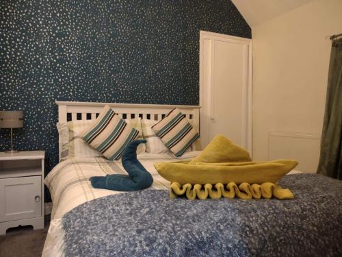 a bedroom with a bed with a wall covered in polka dots at The Shoulder at Hardstoft in Hardstoft