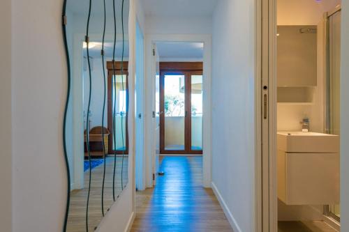 a hallway with a mirror next to a bathroom at Salamar Saler Golf in El Saler